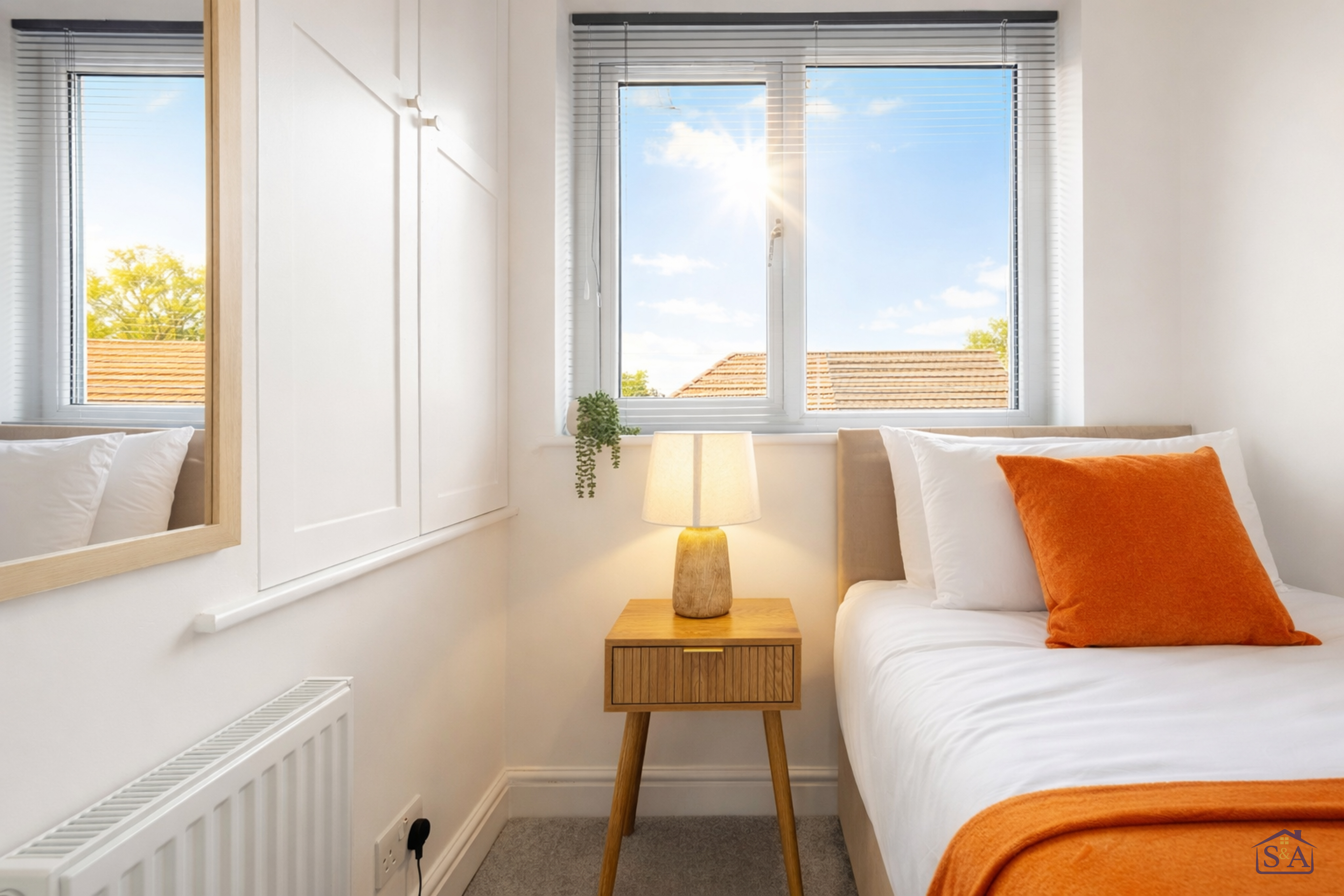 Bright single bedroom with bedside table and built-in storage