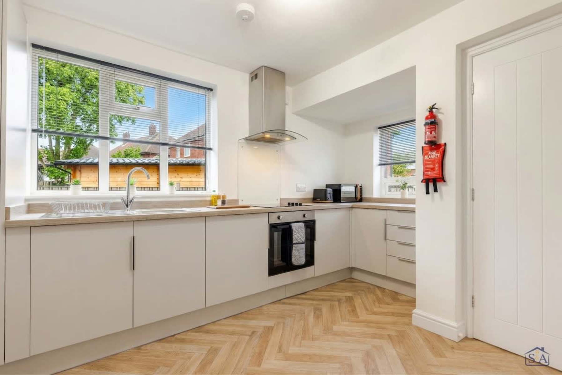 Fully equipped modern kitchen with herringbone flooring